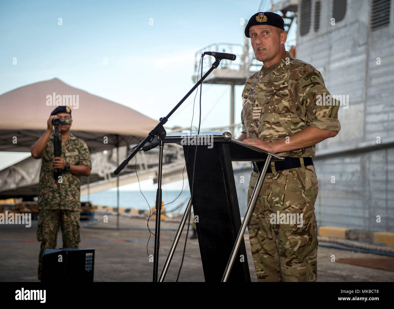 180503-N-MW694-0107 TAWAU, Malaysia (May 3, 2018) Royal Navy Capt. Peter Olive, Pacific Partnership 2018 (PP18) Deputy Mission Commander, speaks during the PP18 Tawau mission stop closing ceremony, May 3. PP18’s mission is to work collectively with host and partner nations to enhance regional interoperability and disaster response capabilities, increase stability and security in the region, and foster new and enduring friendships across the Indo-Pacific Region. Pacific Partnership, now in its 13th iteration, is the largest annual multinational humanitarian assistance and disaster relief prepar Stock Photo