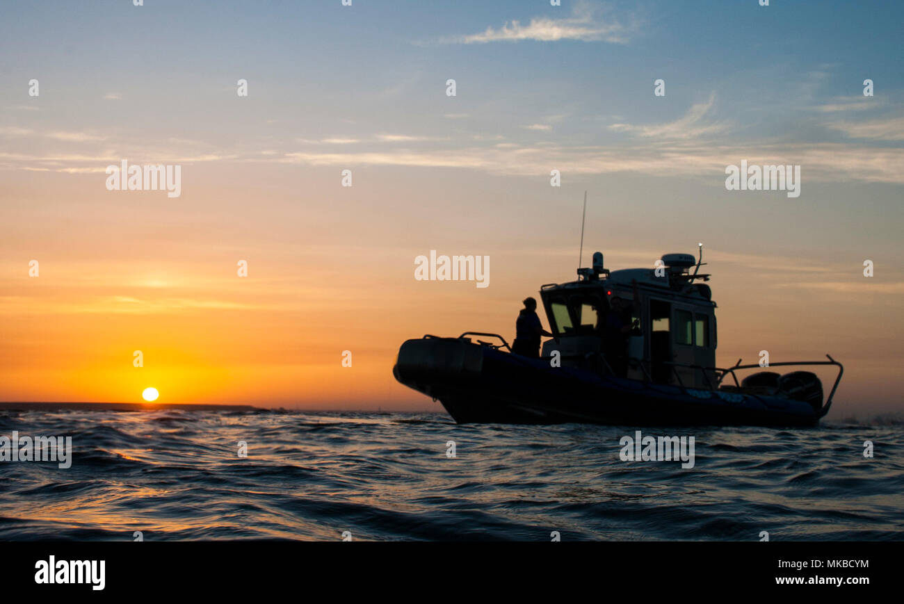 Marine Patrol Airmen assigned to the 6th Security Forces Squadron patrol the 7.2 mile coastline of MacDill Air Force Base, Fla., May 4, 2018. On April 7, 2018, these Airmen assisted five local and federal Tampa Bay agencies in rescuing five people after their boat capsized near Davis Island. (U.S. Air Force photo by Airman 1st Class Adam R. Shanks) Stock Photo