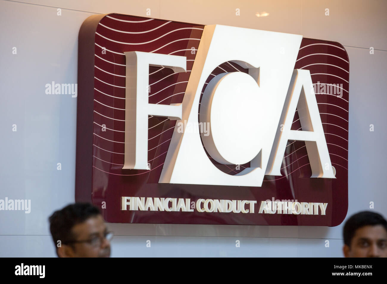 Financial Conduct Authority (FCA) offices, North Colonnade, Docklands, London. Employees exiting through security gates at lunchtime. Stock Photo
