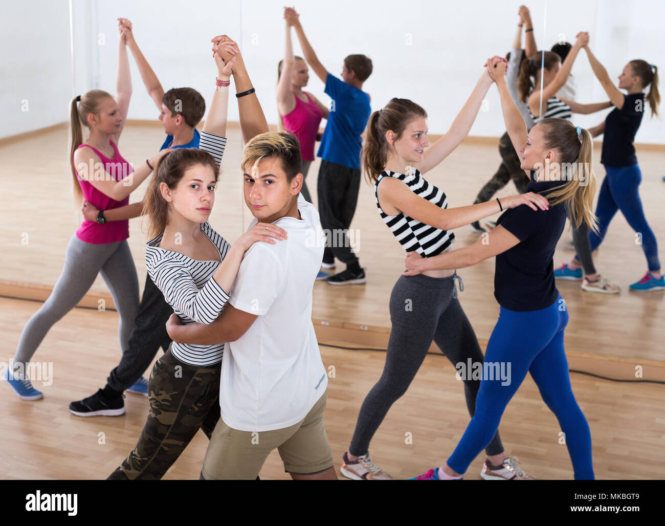 Portrait of smiling teenagers dancing of partner dance in studio Stock