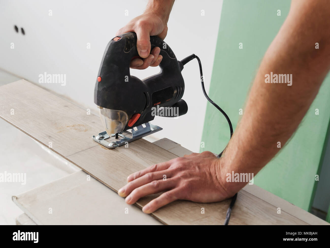 Installing Laminate Flooring Worker Cut Part Of The Board With An Electric Jigsaw Stock Photo Alamy