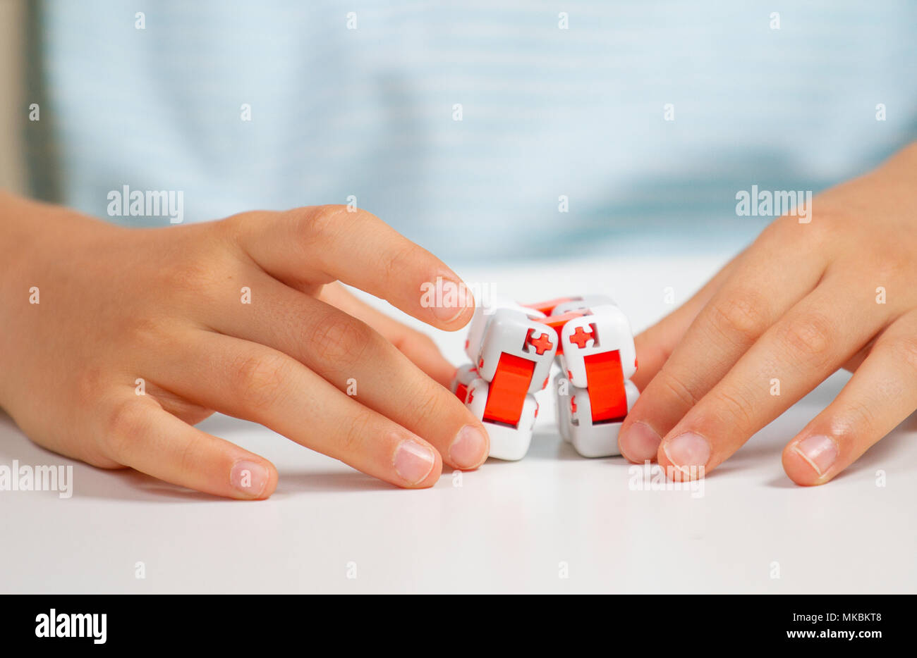 Colorful fingers antistress toy in child hand Stock Photo