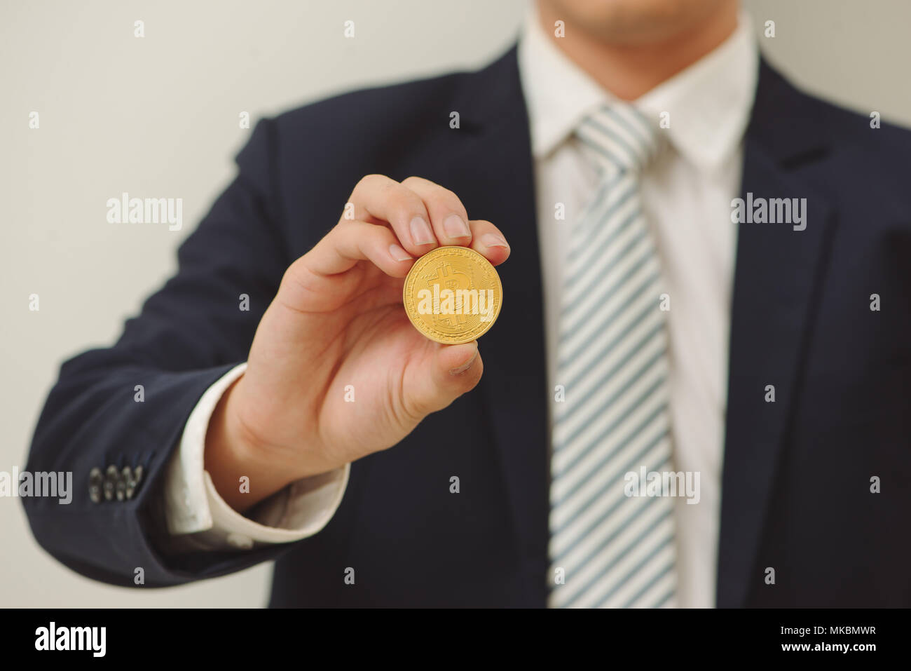 Handsome young man holding bitcoin serious face thinking about question,  very confused idea Stock Photo - Alamy