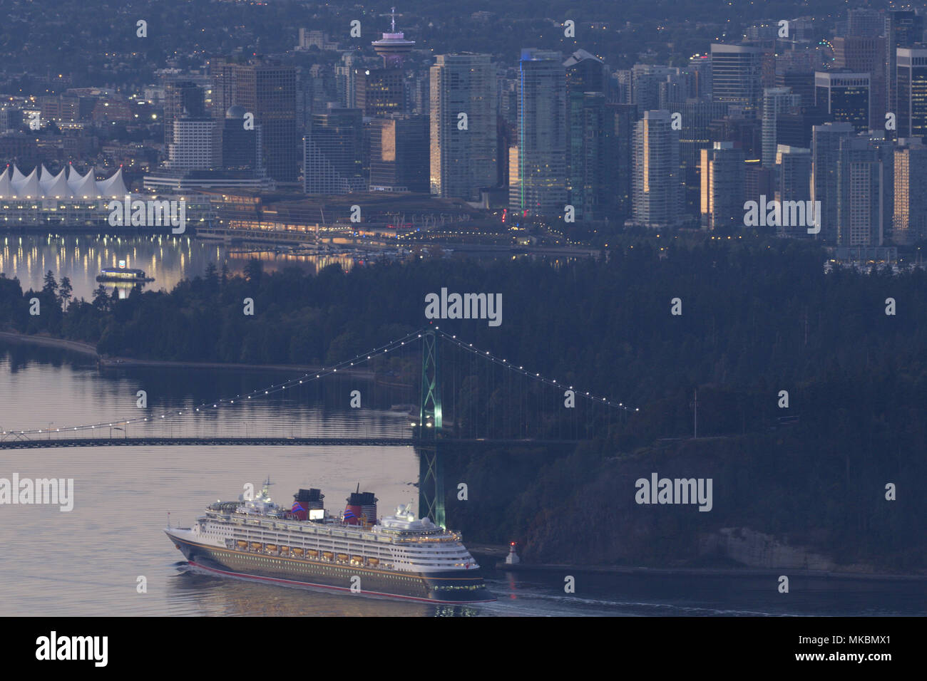 Morning city view of downtown Vancouver from Cypress Mountain High View Lookout with Lions Gate Bridge and ship passing beneath. Stock Photo