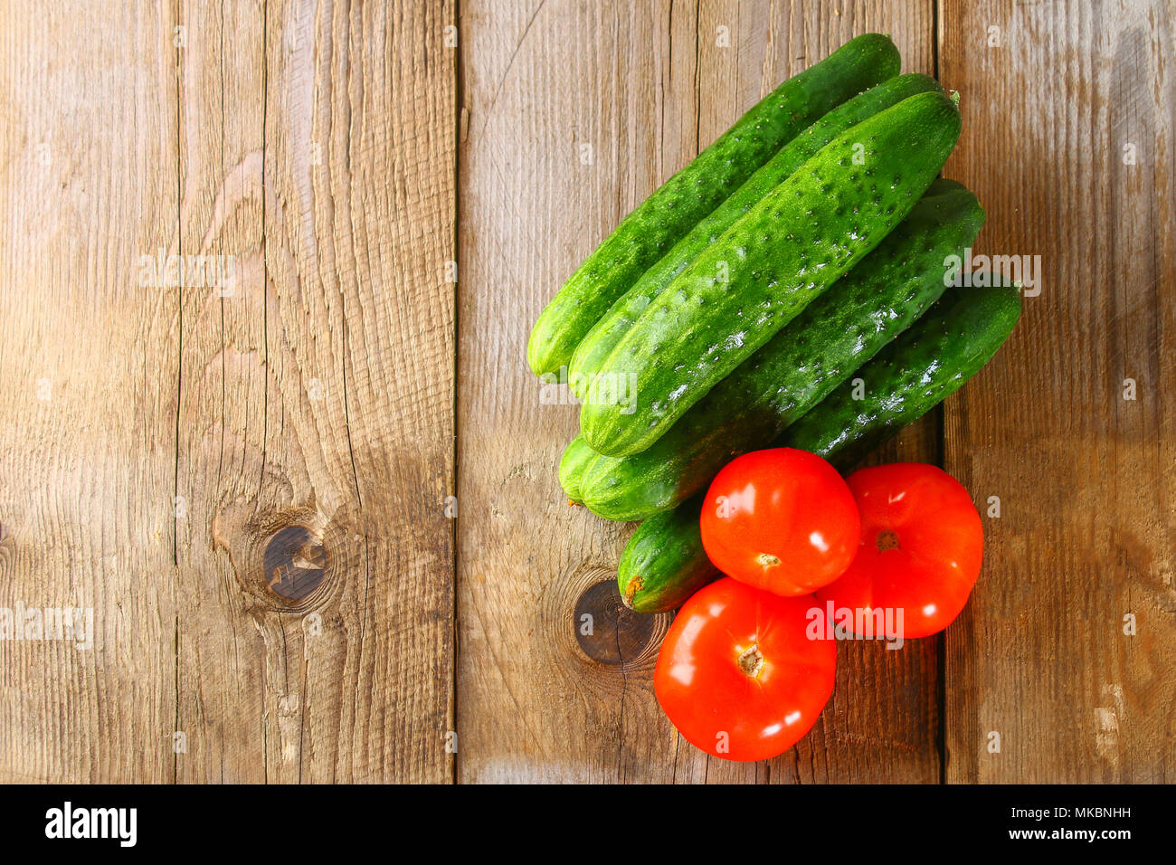 Tomatoes and cucumbers on an old wooden table Stock Photo - Alamy