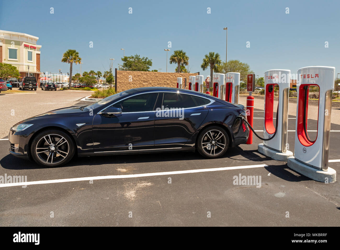 West Melbourne, Florida - A Tesla Model S charging at an electric car Supercharger station. Stock Photo