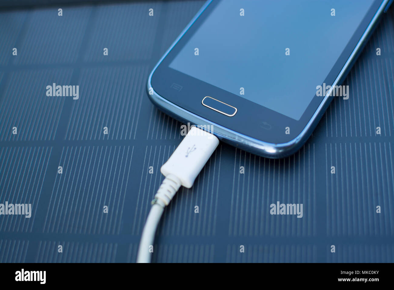 Use of renewable energy Mobile Phone Chargers on grass in nature with