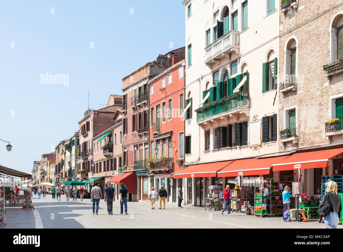Busy pedestrian street scene in via Garibaldi, Castello, Venice, Veneto, Italy with local Venetians and tourists shopping at stores and a  Coop superm Stock Photo