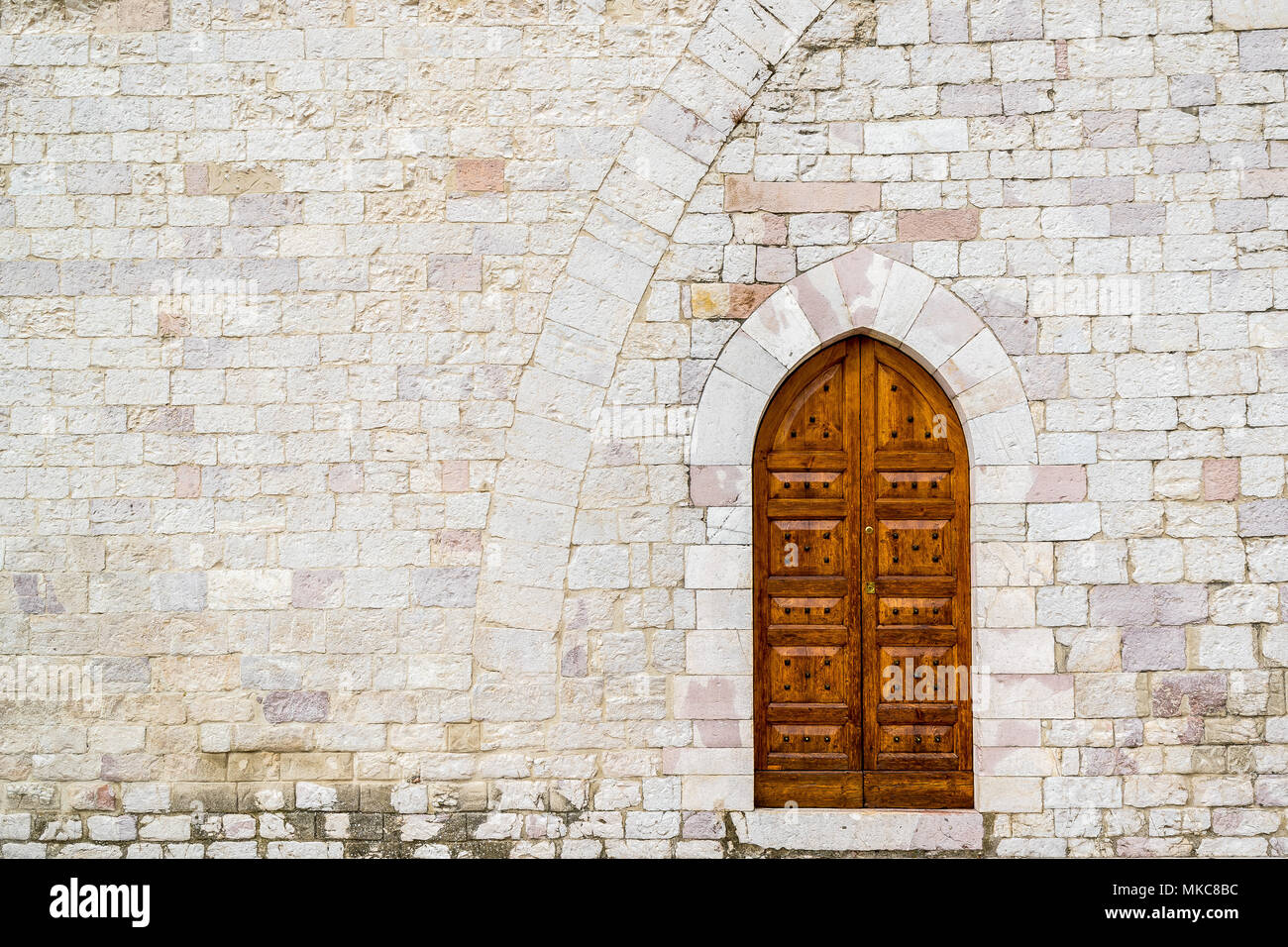 An old wooden door with an ancient stone wall Stock Photo - Alamy
