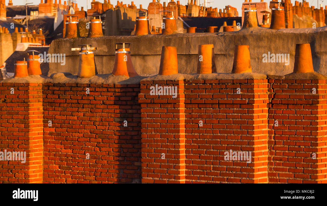 View Across Roofscape of Redbrick and Terracotta Chimneys and Chimneypots Stock Photo