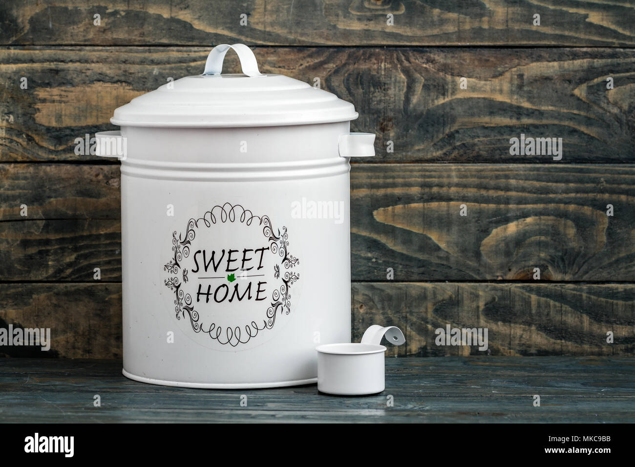 Vintage potato onion and garlic storage containers on blue Stock Photo