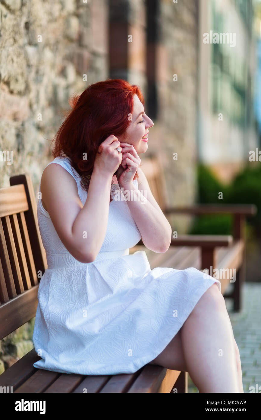 Beautiful woman sits on bench hi-res stock photography and images - Alamy