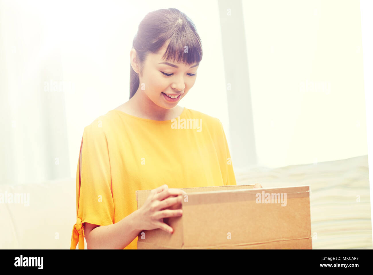 happy asian young woman with parcel box at home Stock Photo - Alamy