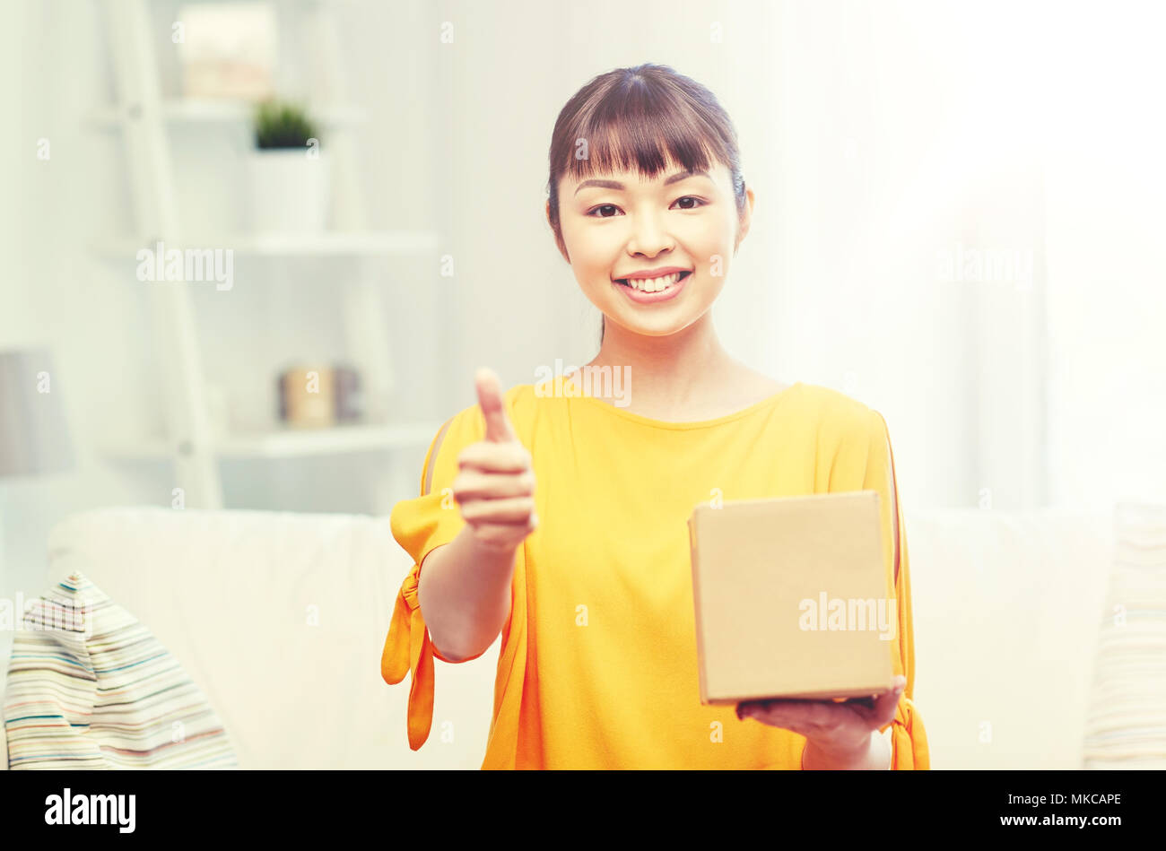 happy asian young woman with parcel box at home Stock Photo - Alamy