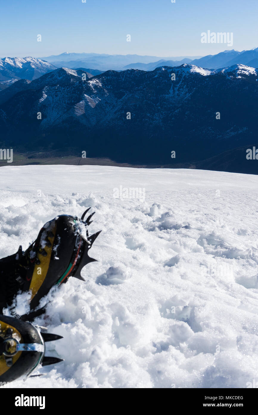 Crampons close up for extreme hiking on snow covered mountains. Hiking on mountain Dourdouvana in Peloponnese Greece Stock Photo