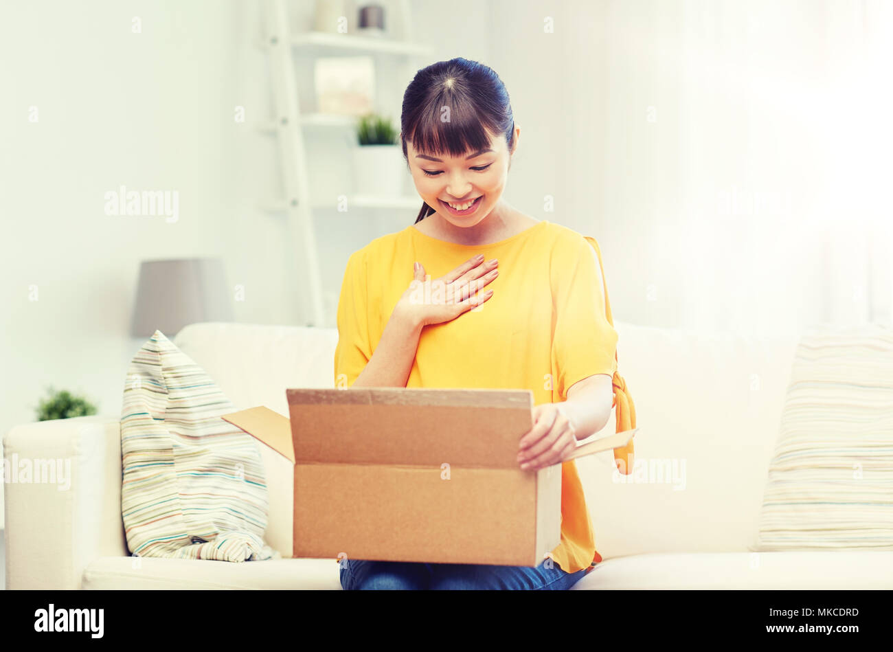 happy asian young woman with parcel box at home Stock Photo - Alamy