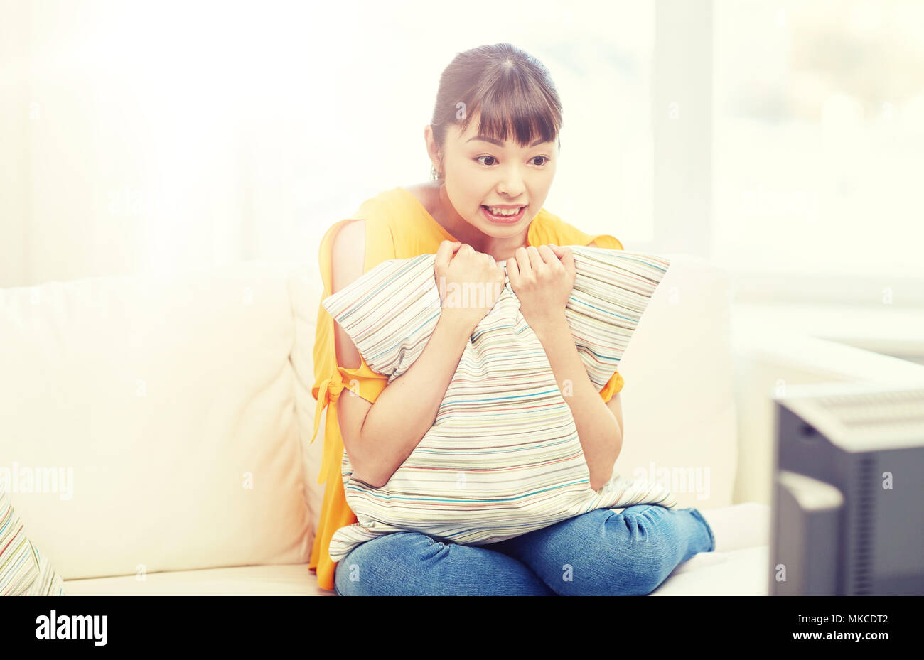 asian young woman watching tv at home Stock Photo