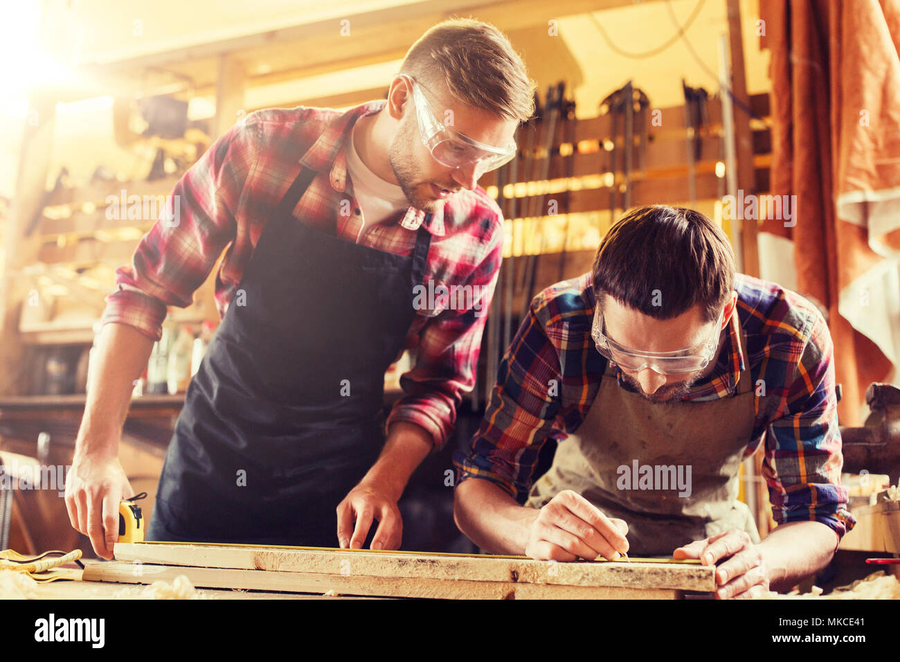 carpenters with ruler and wood plank at Stock Photo Alamy