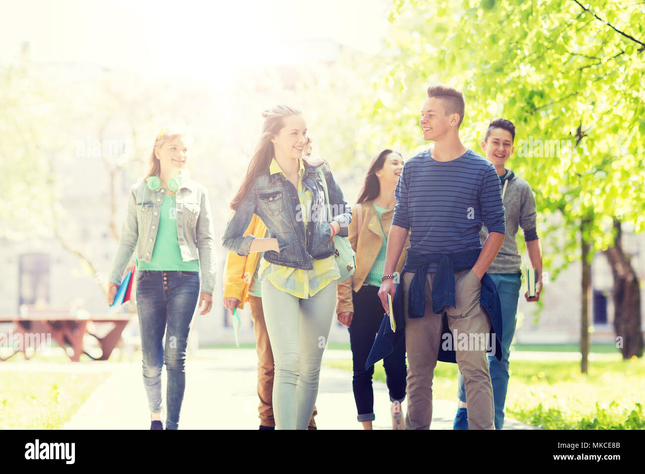 group of happy teenage students walking outdoors Stock Photo - Alamy