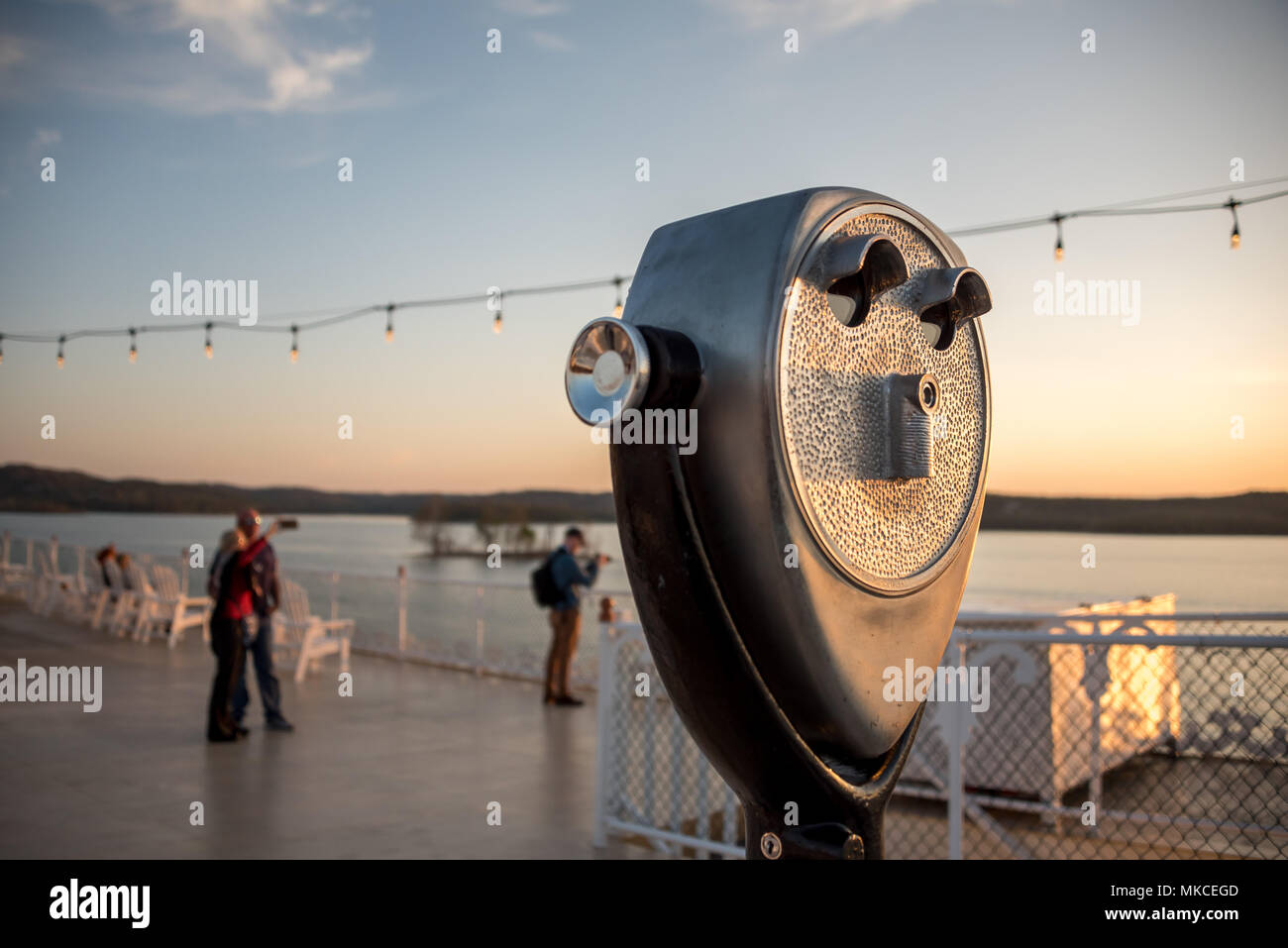 Showboat Branson Belle top deck at sunset, a couple taking a selfie on top deck, old-fashioned viewfinder in foreground, Table Rock Lake background. Stock Photo
