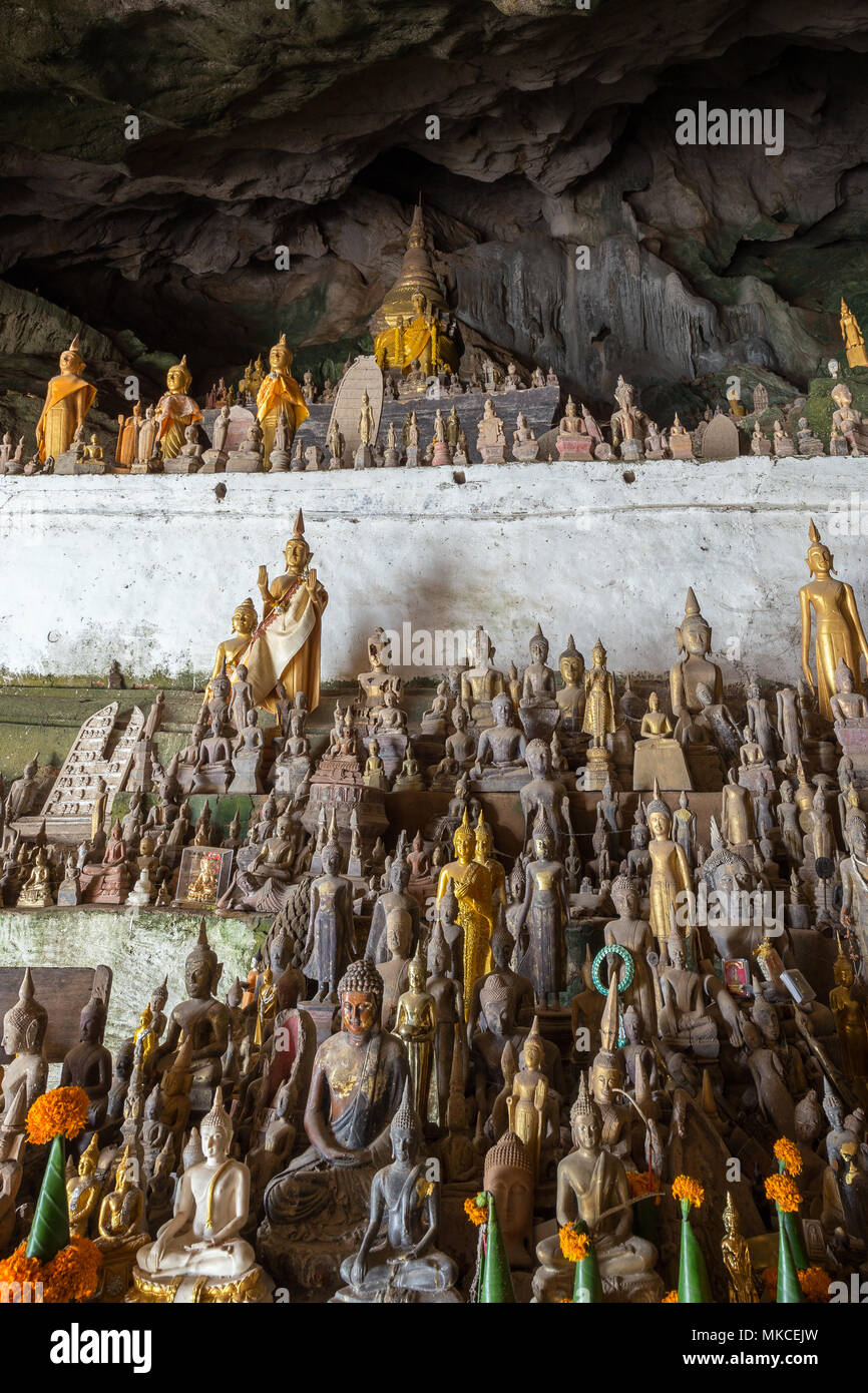 Hundreds of old golden and wooden Buddha statues inside the Tham Ting Cave at the famous Pak Ou Caves near Luang Prabang in Laos. Stock Photo