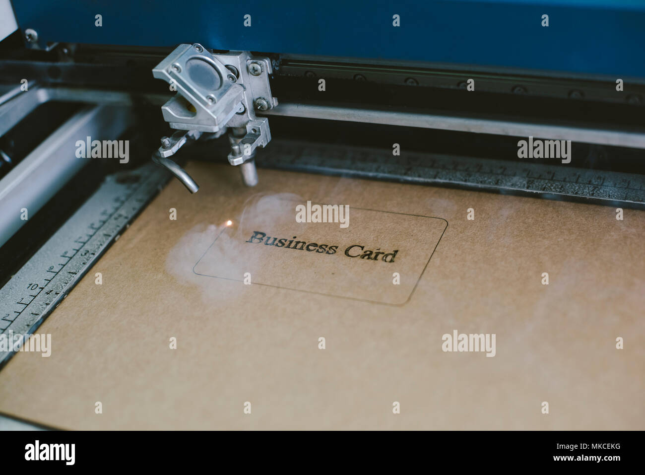 Laser engraving business card from recycled cardboard Stock Photo Alamy
