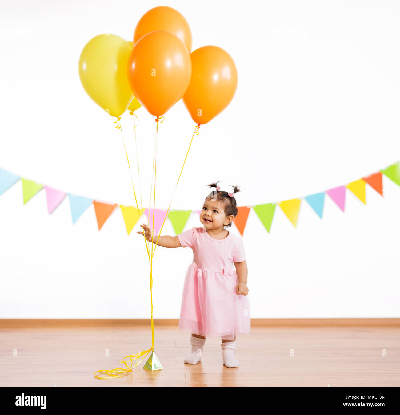happy baby girl with balloons on birthday party Stock Photo - Alamy