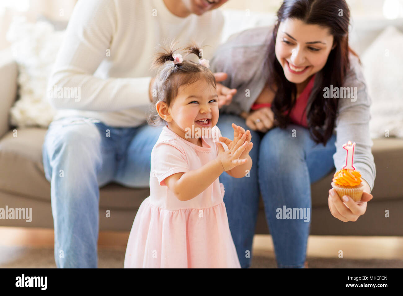 baby girl with parents at home birthday party Stock Photo - Alamy