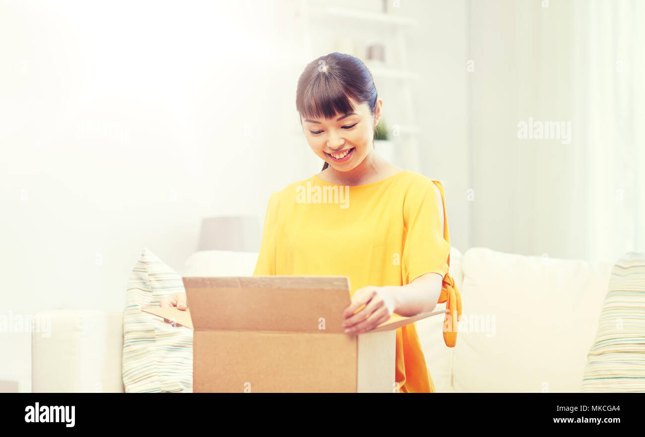 happy asian young woman with parcel box at home Stock Photo - Alamy