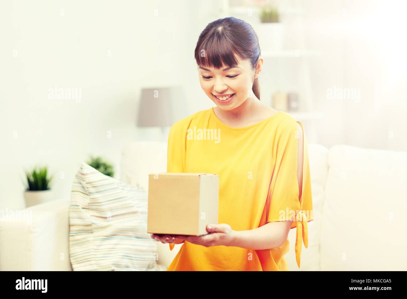 happy asian young woman with parcel box at home Stock Photo - Alamy