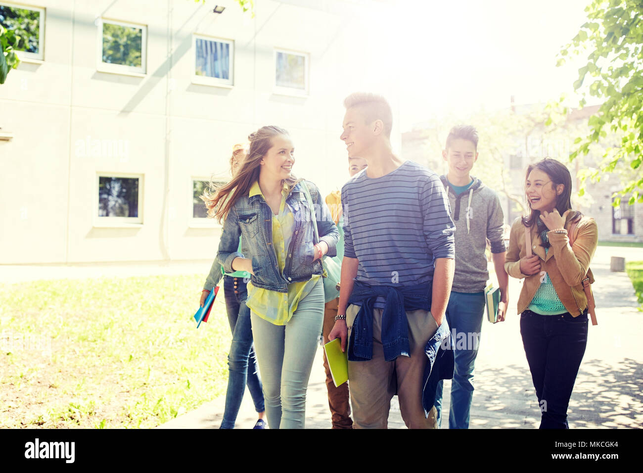 group of happy teenage students walking outdoors Stock Photo - Alamy