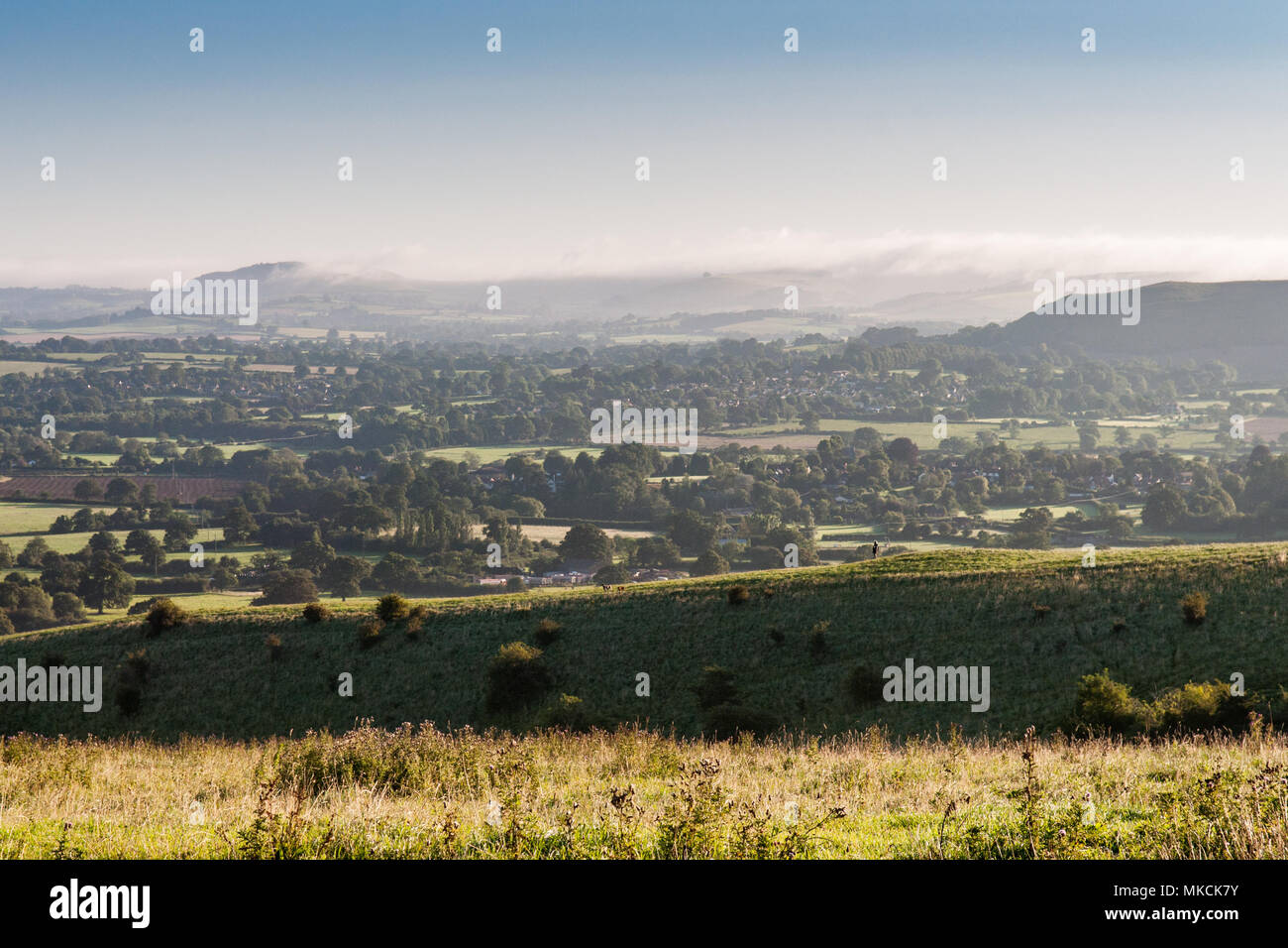 Looking over the Blackmore Vale, a rural agricultural valley in North Dorset, from the summit of Okeford Hill in the Dorset Downs. Stock Photo