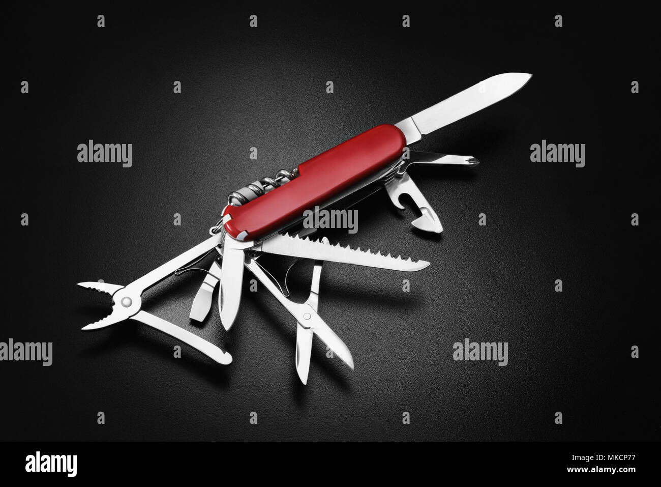 Many task swiss army knife on black background. Multi-tool Stock Photo
