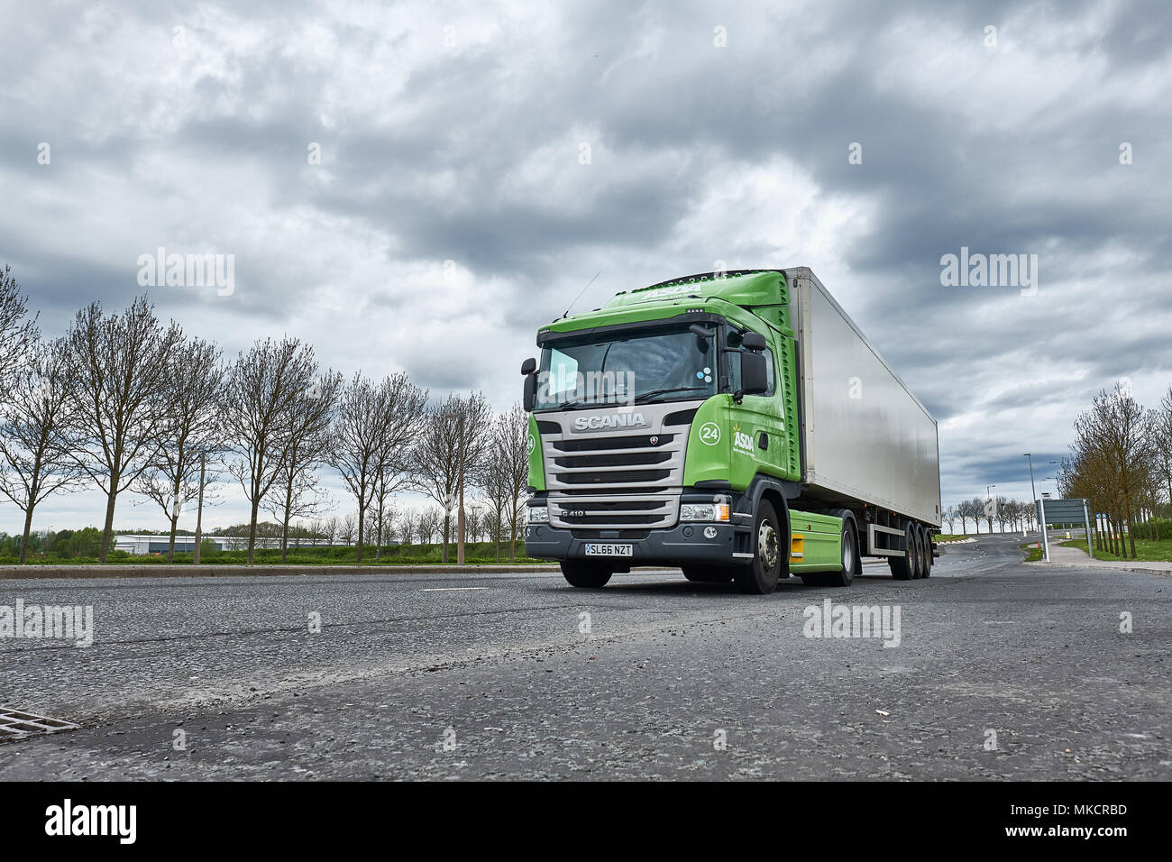 Asda Scania delivery trailer and lorry driving along Townhead Ave Motherwell Glasgow ML1 4XN Scotland Stock Photo