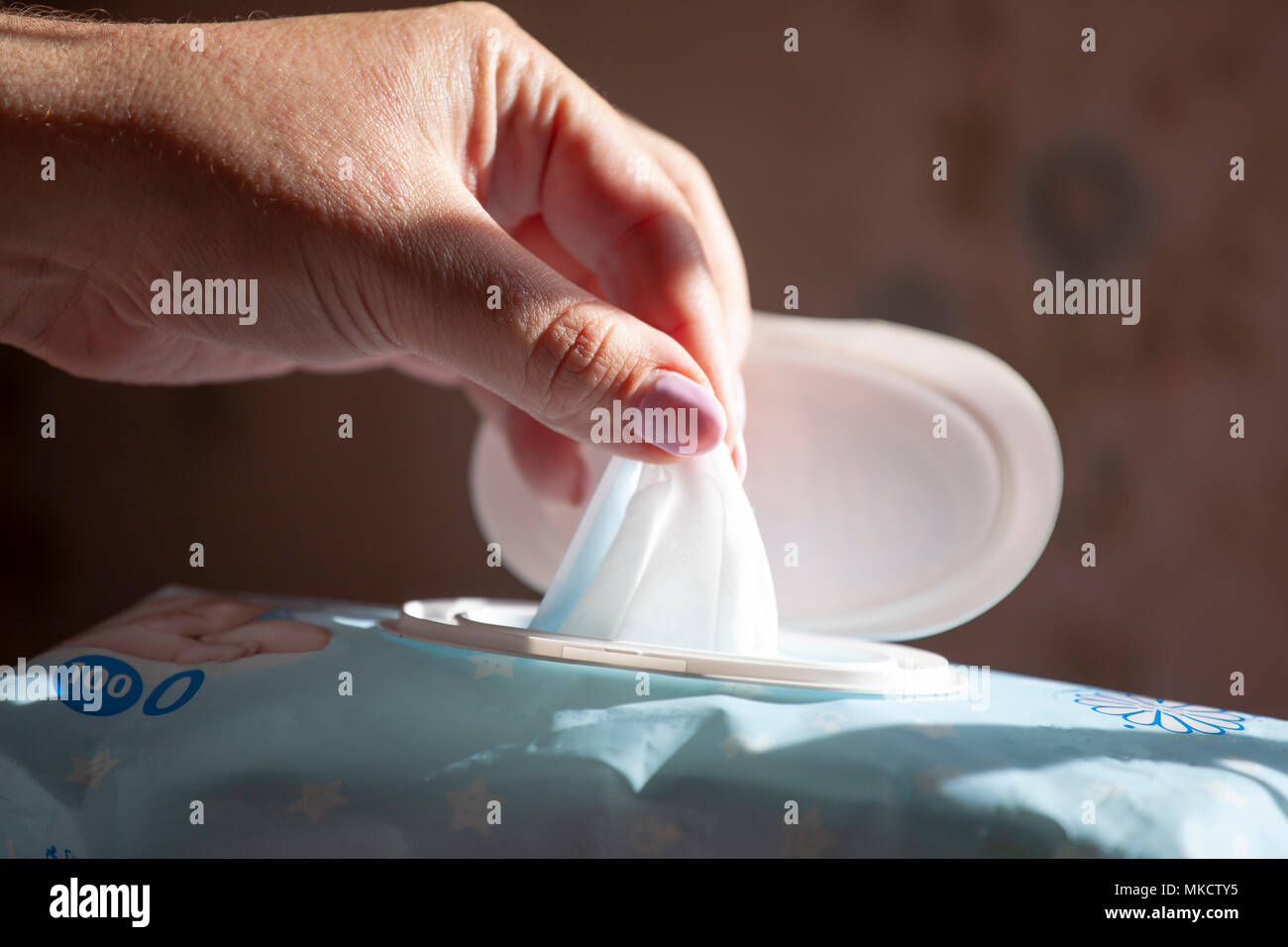 Hand picked a wet wipes in package box, Wet wipes in a woman's hand