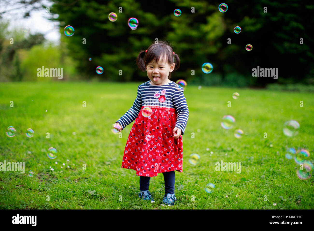 baby girl play bubble at spring garden Stock Photo - Alamy