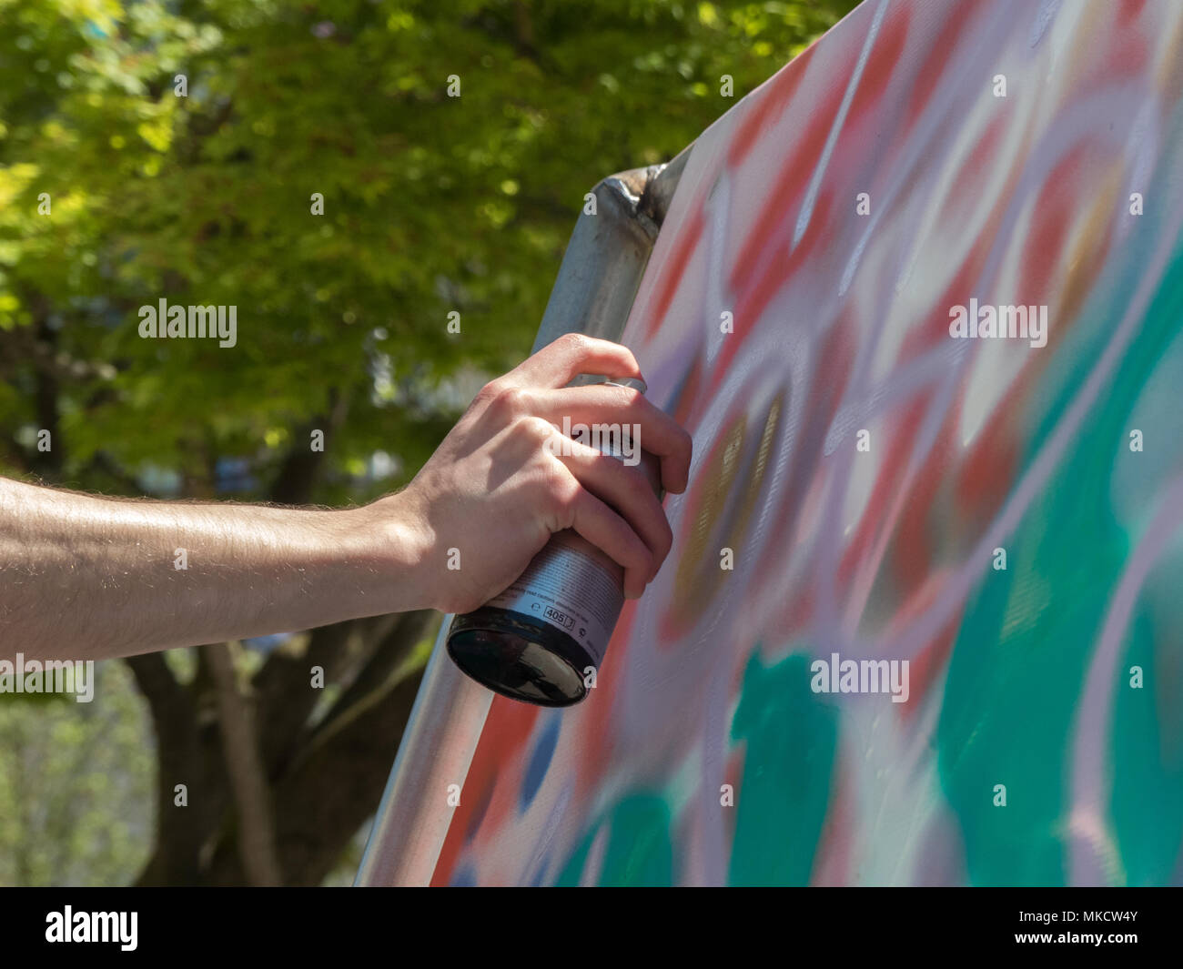 Artist painting outdoor spray graffiti paint can Stock Photo - Alamy