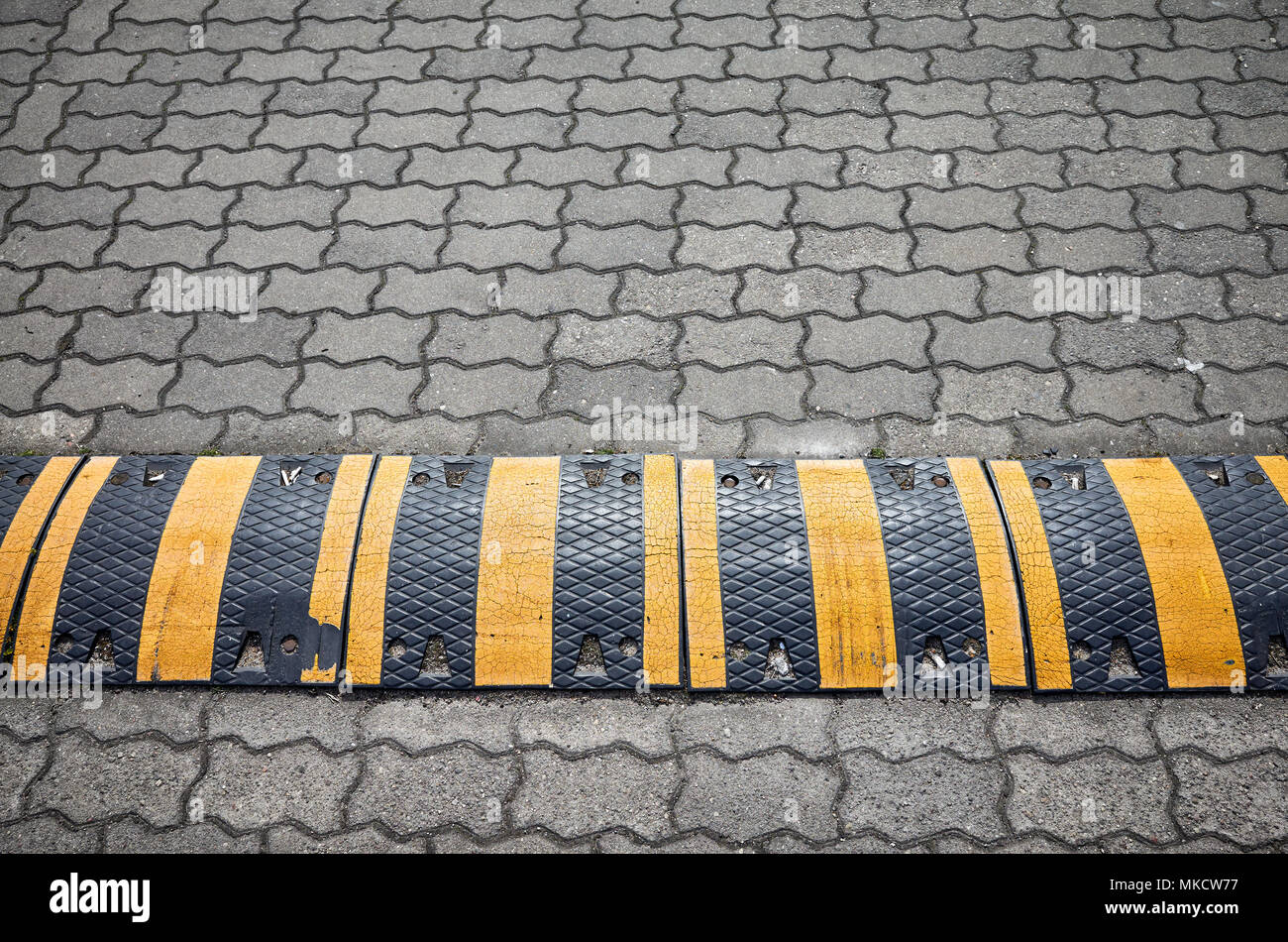 Speed bump on a paved road, selective focus. Stock Photo