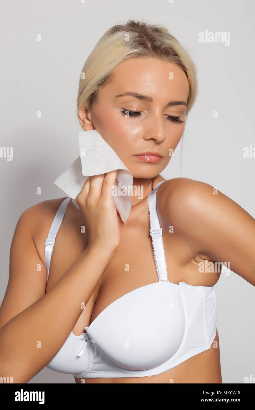 Young woman clean neck with wet wipes, body breast lingerie Stock Photo -  Alamy