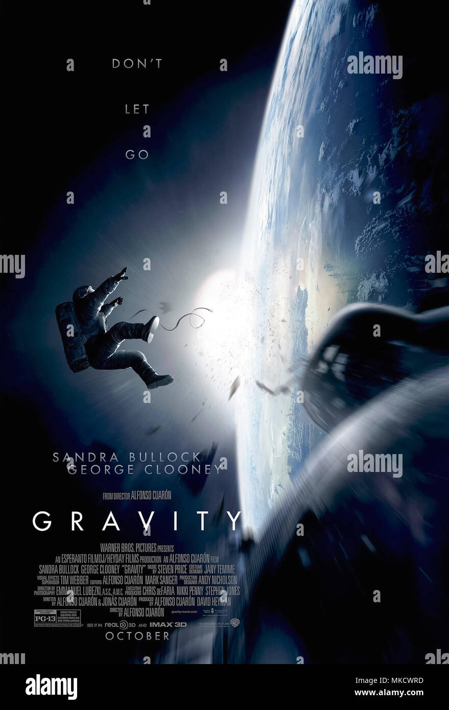 Gravity (2013) directed by Alfonso Cuarón and starring Sandra Bullock, George Clooney and Ed Harris. Space debris from a satellite breakup leaves two astronauts on a spacewalk stranded alone in space. Stock Photo