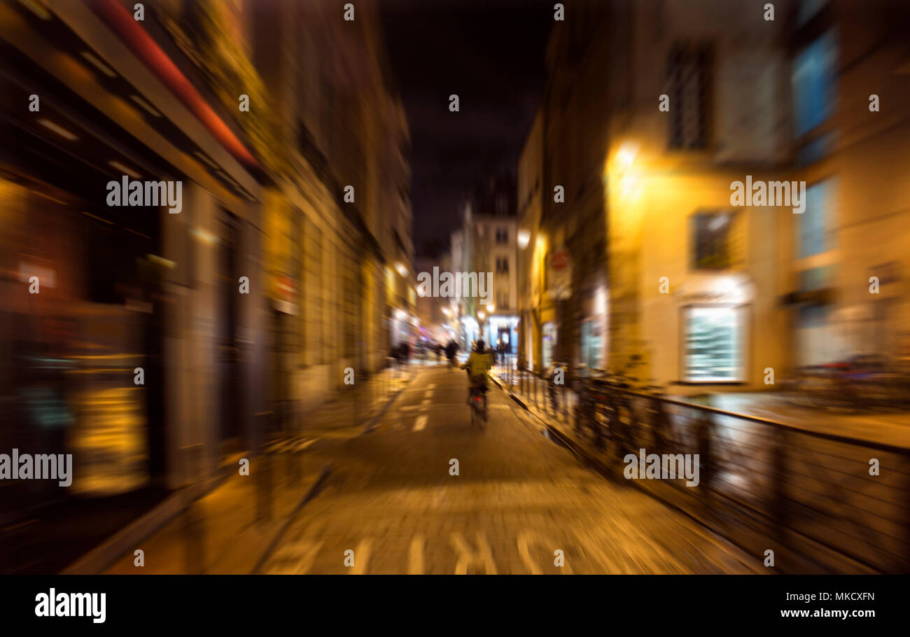 Blurry motion image of people walking on street at night in Paris Stock ...