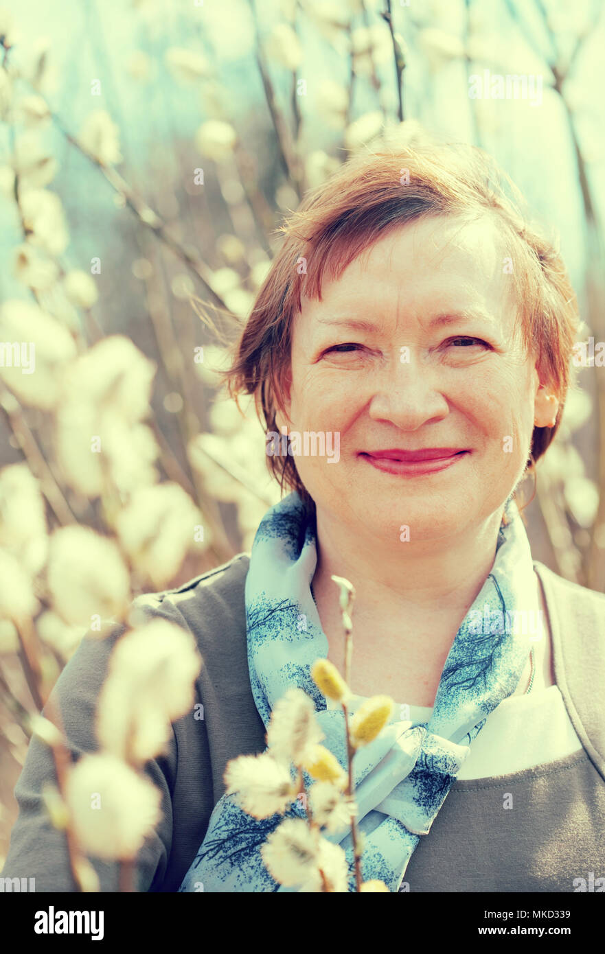 portrait of mature woman in spring pussywillow plant Stock Photo - Alamy