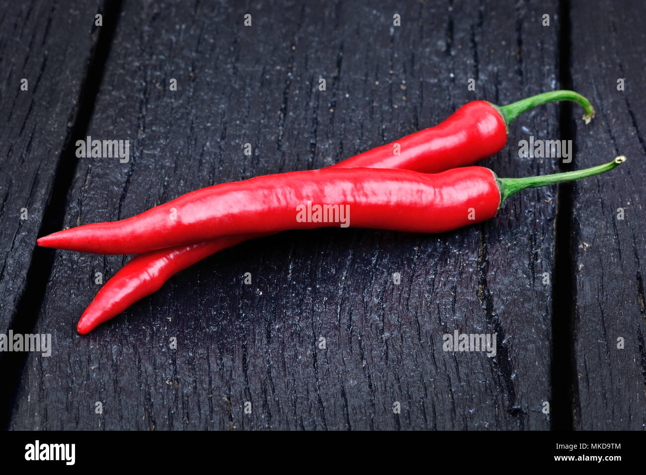 Chili pepper on black wood table Stock Photo