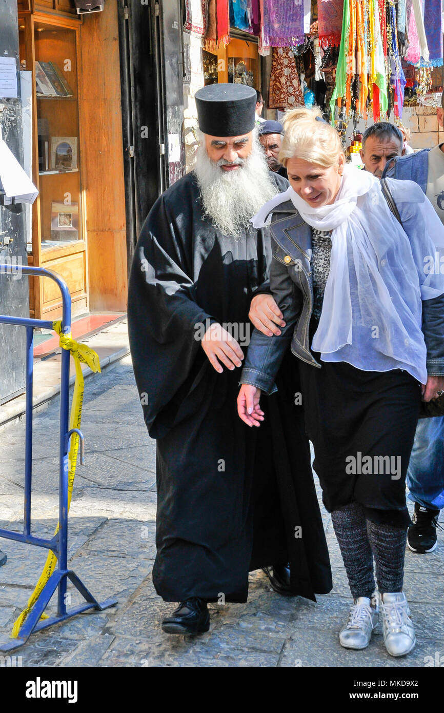 Orthodox christian priest accompany visitor in Old Jerusalem, capital of Israel, Asia, Middle Eas Stock Photo