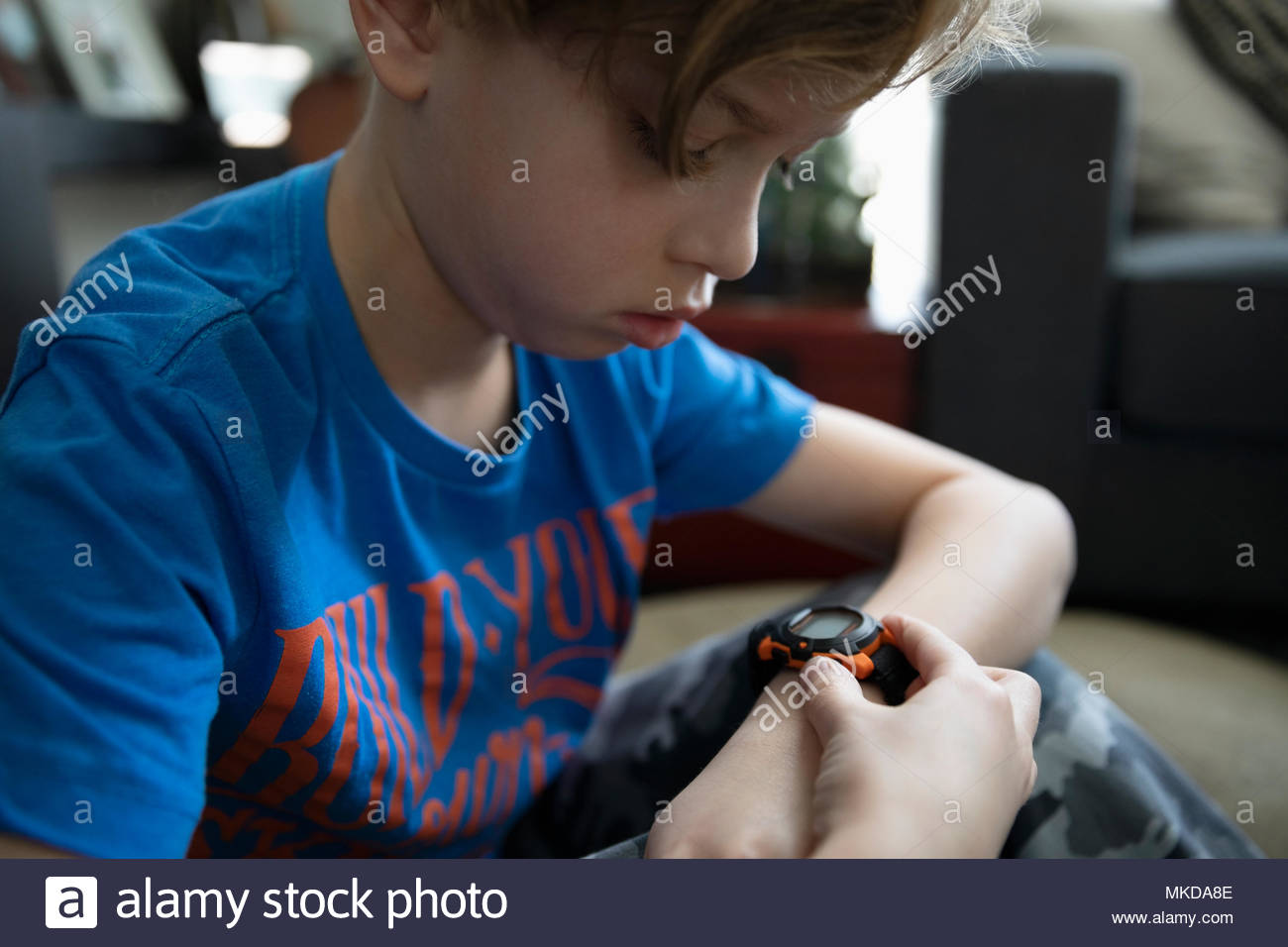 Close up boy checking wristwatch Stock Photo