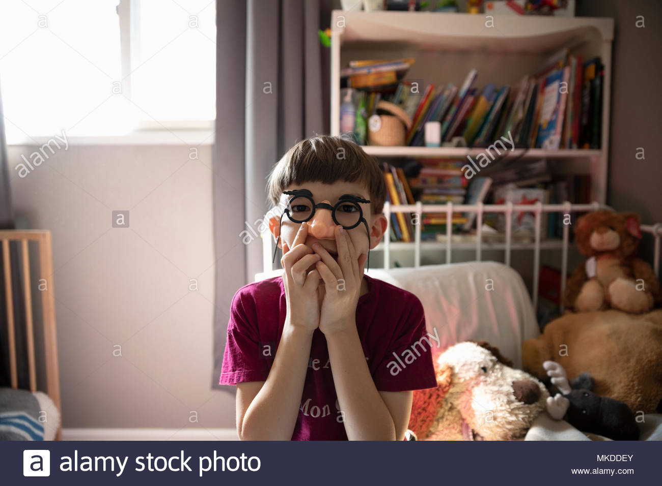 Portrait playful boy wearing silly glasses Stock Photo