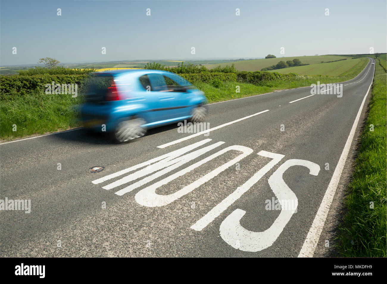 A SLOW sign on the brow of a hill on a road through the Dorset