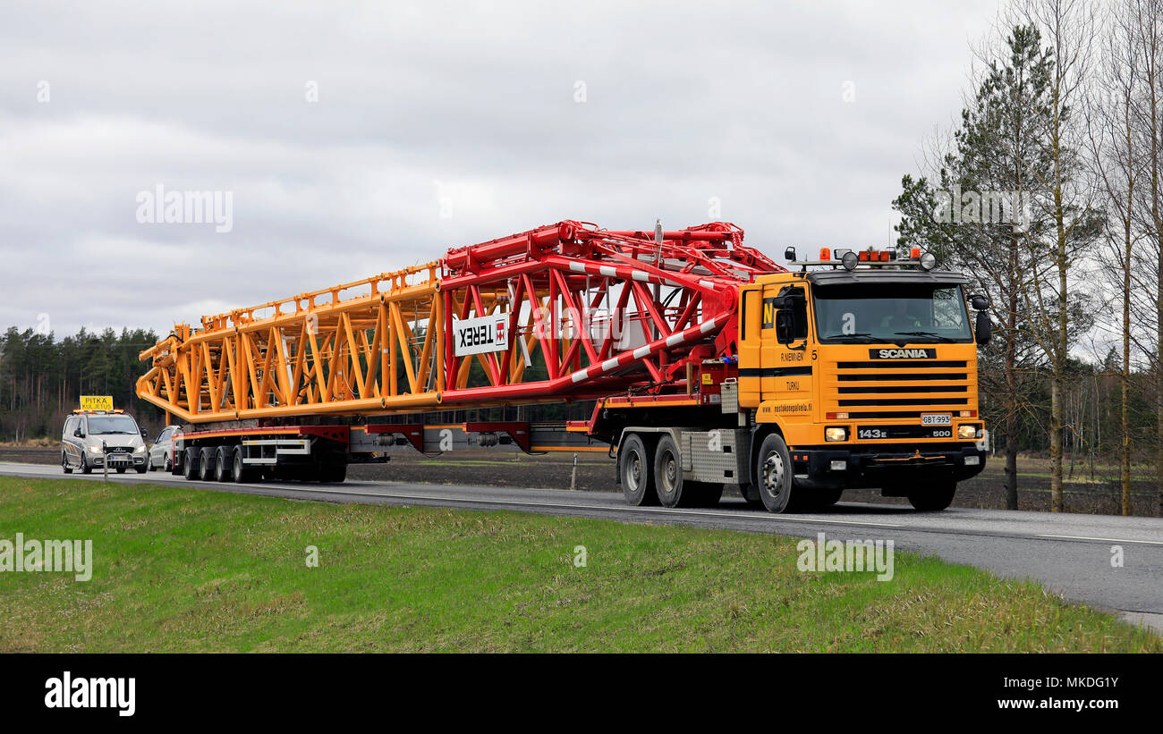 45 metres long oversize transport of Terex lifting equipment on the road. The load requires a pilot car in front of and behind of the long vehicle. Po Stock Photo