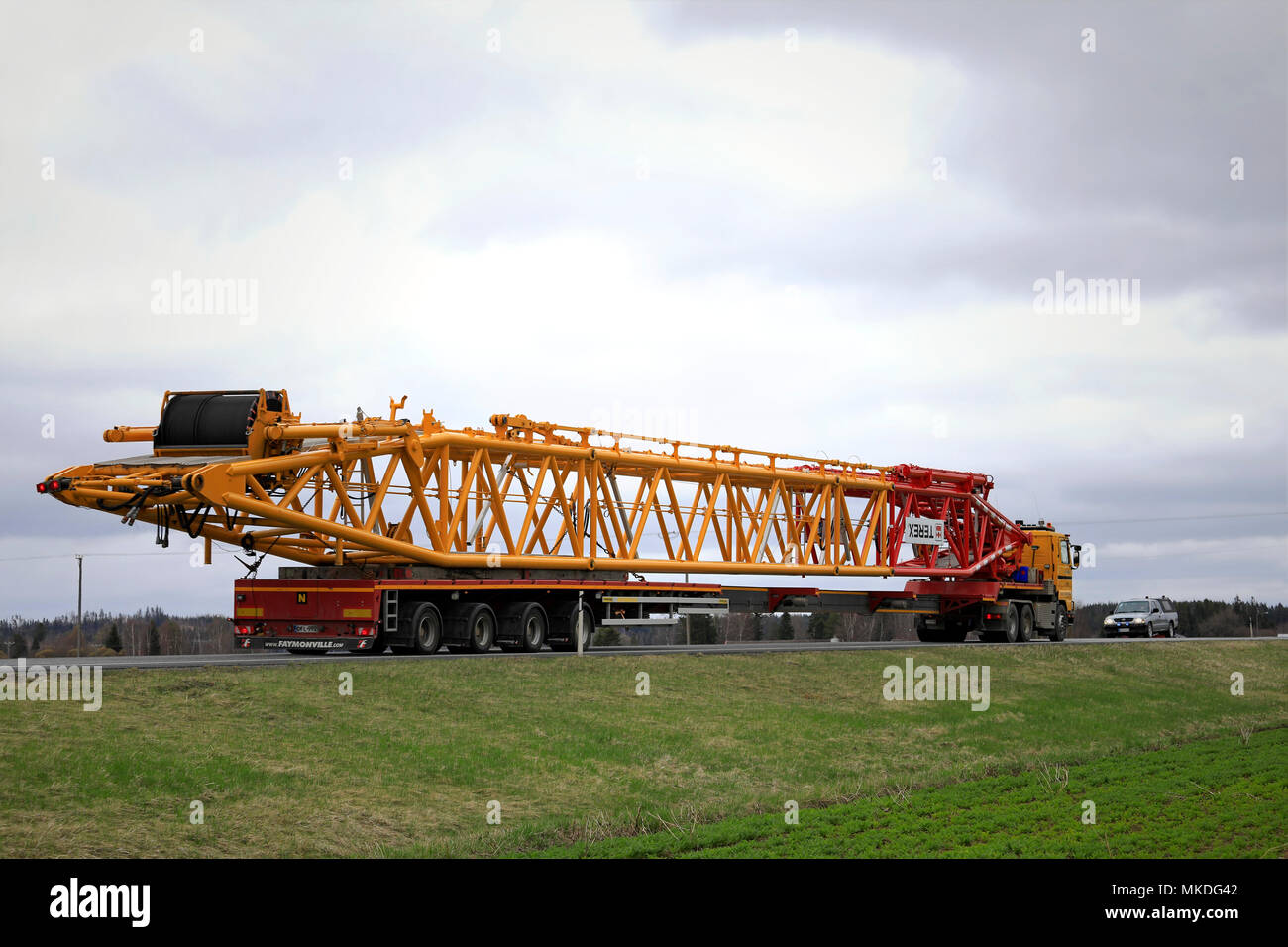 45 metres long oversize transport of Terex lifting equipment on the road. The load requires a pilot car in front of and behind of the long vehicle. Hu Stock Photo