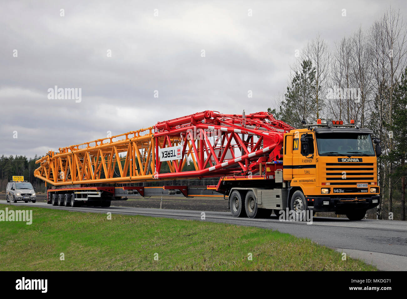 45 metres long oversize transport of Terex lifting equipment on the road. The load requires a pilot car in front of and behind of the long vehicle. Po Stock Photo
